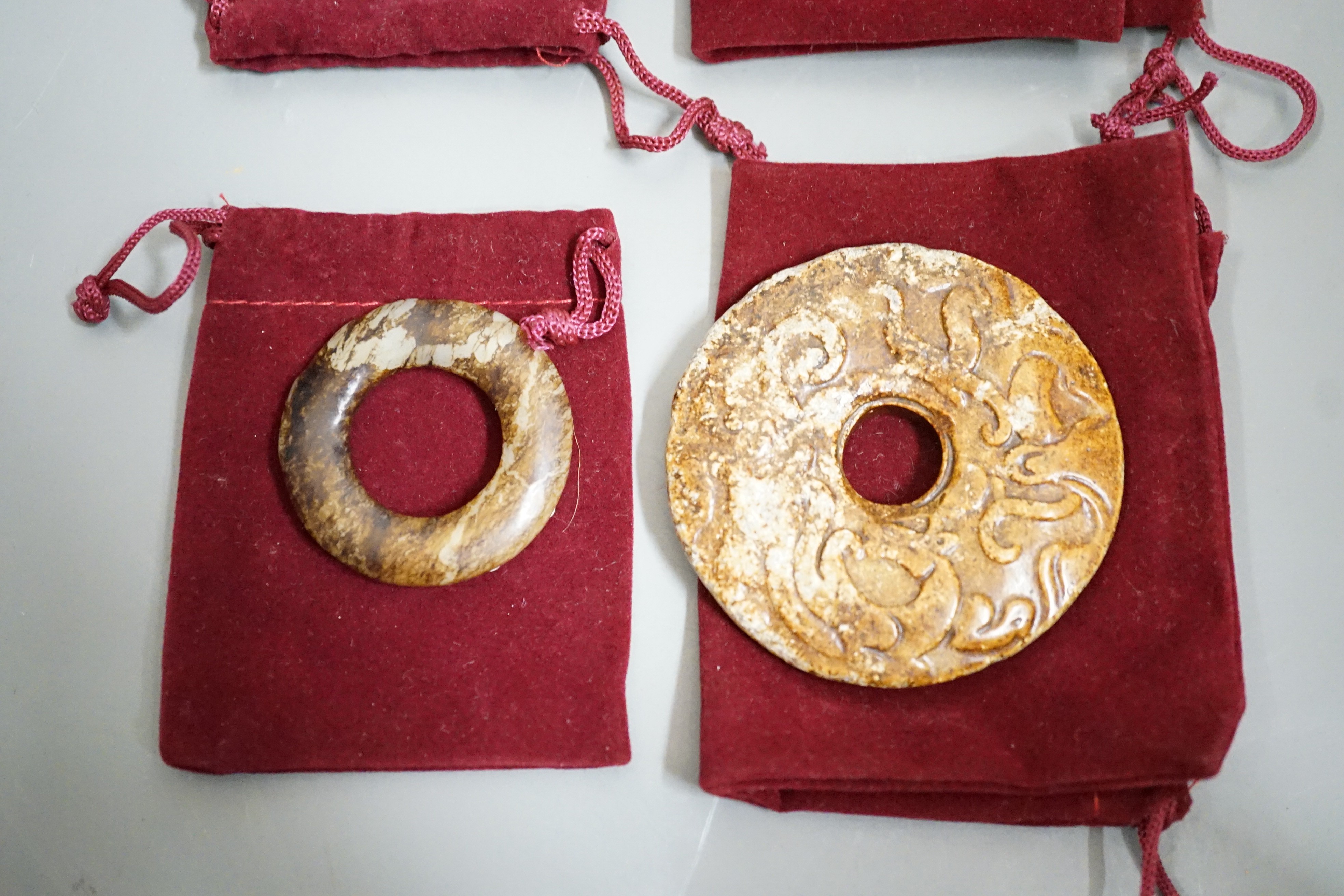 Four Chinese archaistic jade carvings - three bi discs and a cicada, largest 7cms